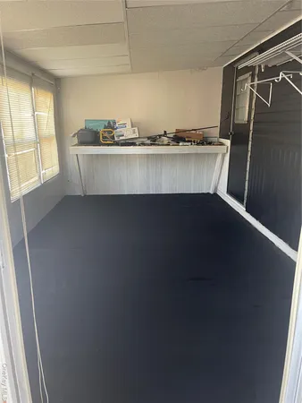a kitchen with a sink a window and cabinets