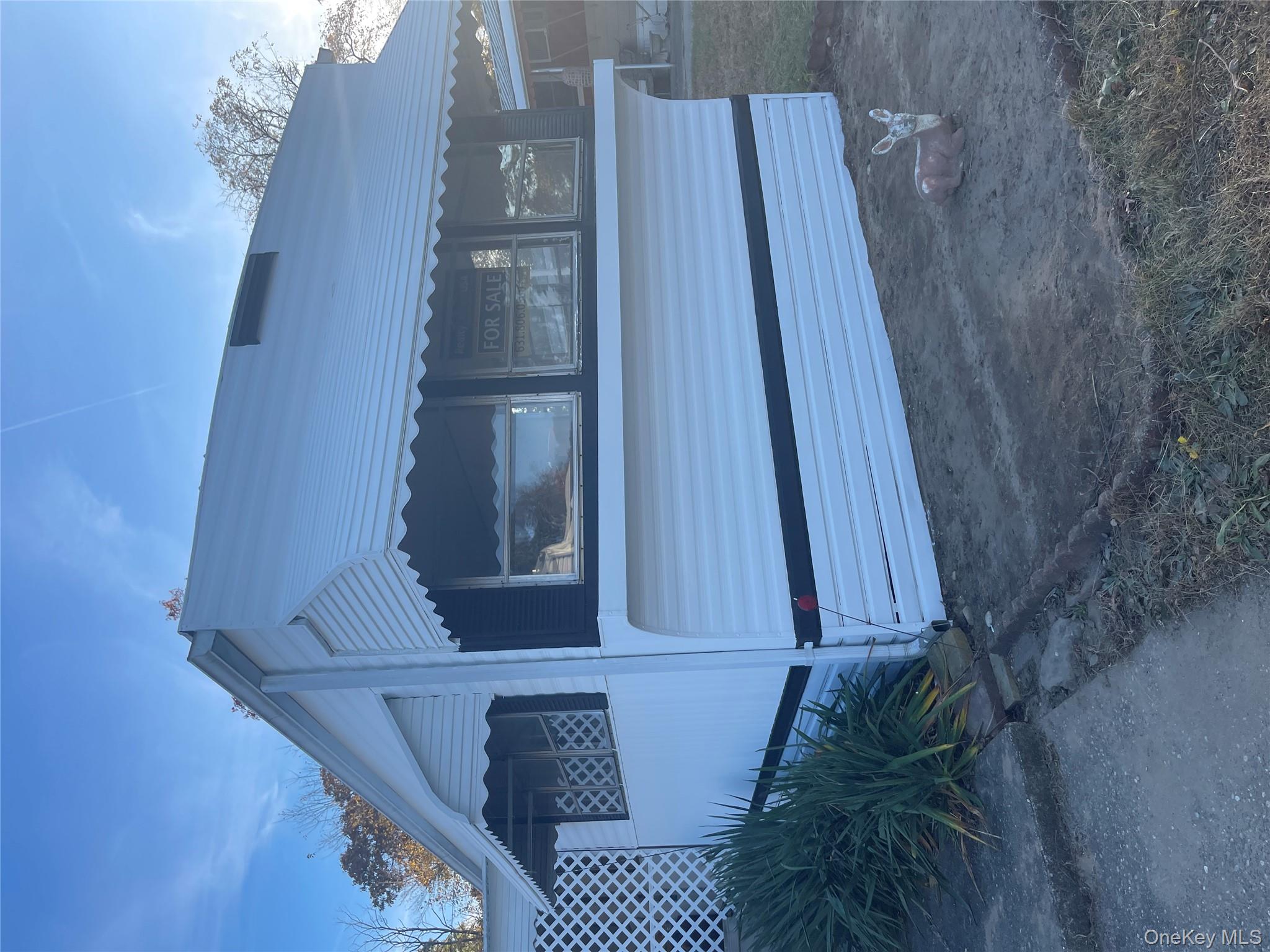 1661 Old Country Road, Unit 308 Riverhead, NY 11901 - Photo 9 of 10 a view of a house with a yard