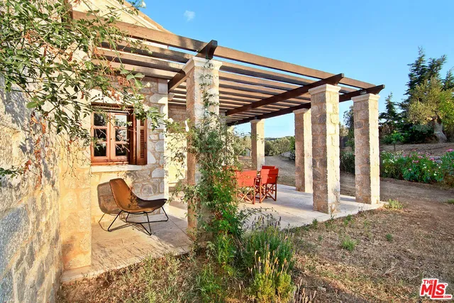 a swimming pool with outdoor seating and yard