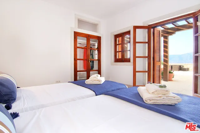 a bathroom with a sink and tub with window