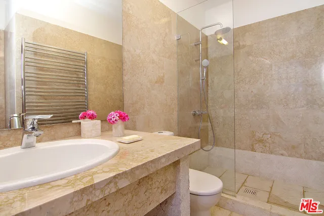 a bedroom with a large bed and a large window