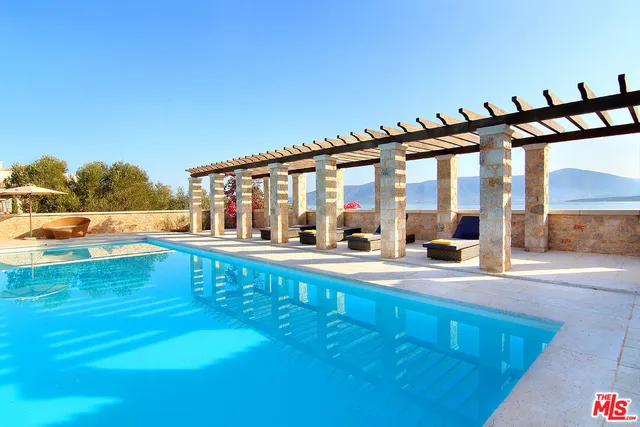 a view of a swimming pool with an outdoor seating
