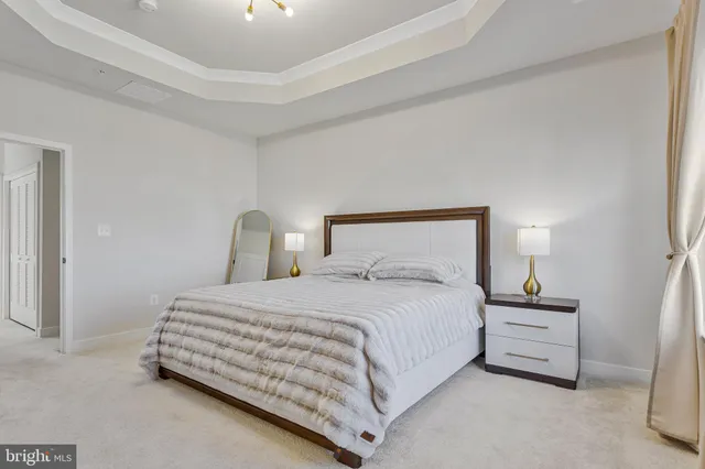 a bedroom with a bed and a lamp