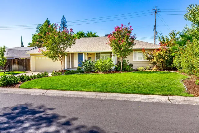 a front view of house with yard and green space