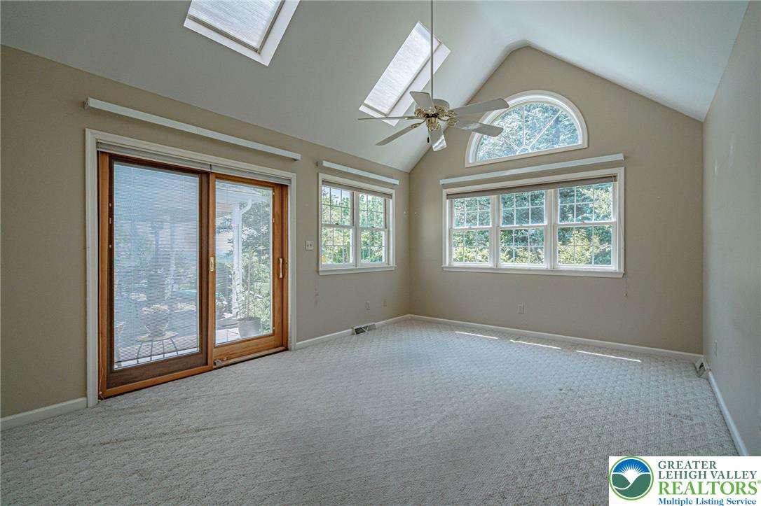 4542 Springfield Drive Coplay, PA 18037 - Photo 23 of 89 Vaulted ceilings and skylights illuminate this spacious room with abundant natural light. Glass sliding doors lead to outdoor area.