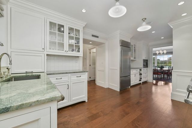 a kitchen with stainless steel appliances granite countertop a stove and cabinets