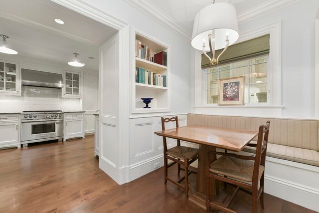 a view of a dining room with furniture a chandelier and wooden floor
