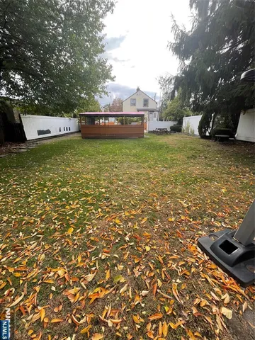 a view of a green field with trees in the background
