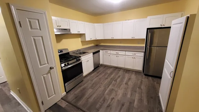 a kitchen with a refrigerator a sink and dishwasher