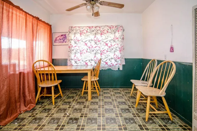 a bedroom with furniture a fireplace and windows