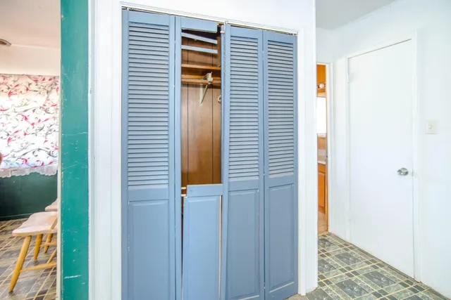 a view of an empty room with closet