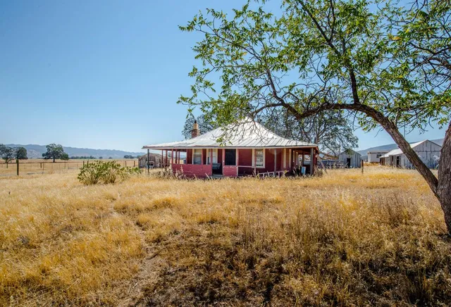 a large white house with a large pool in front of it
