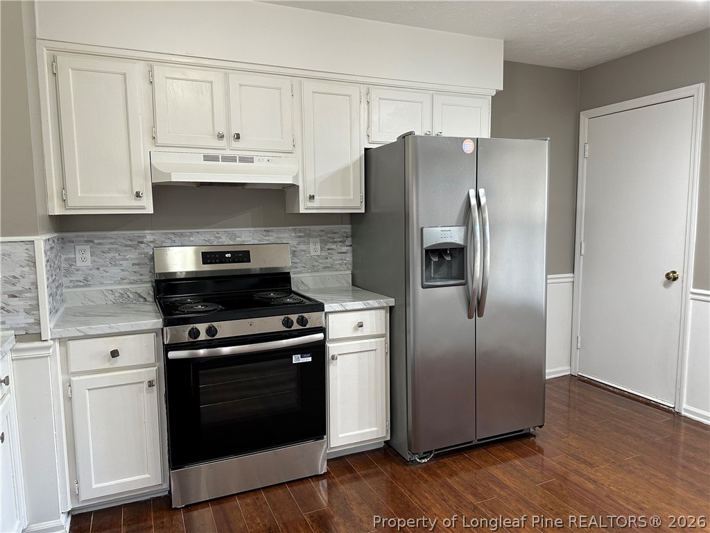 2678 Rivercliff Road Fayetteville, NC 28301 - Photo 6 of 19 a kitchen with stainless steel appliances granite countertop a refrigerator stove and white cabinets
