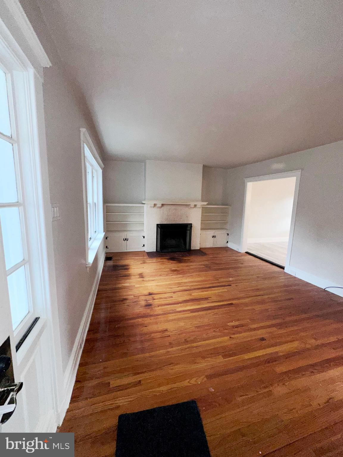 1322 Garfield Avenue Reading, PA 19610 - Photo 5 of 10 a view of empty room with wooden floor and fireplace