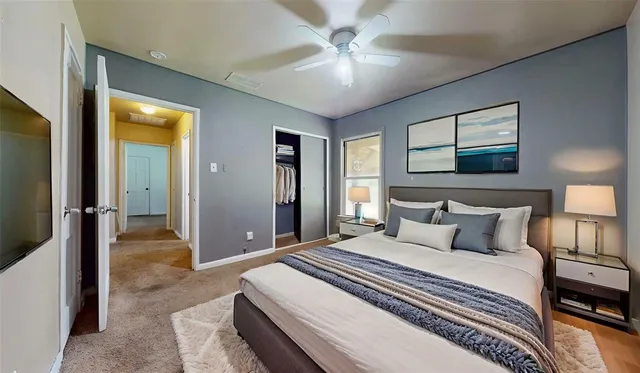 a bedroom with a large bed and a chandelier