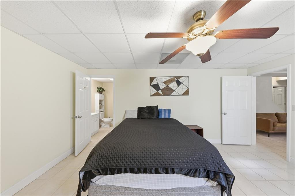 260 Tabor Forest Drive Oxford, GA 30054 - Photo 12 of 20 a bedroom with a bed and a chandelier