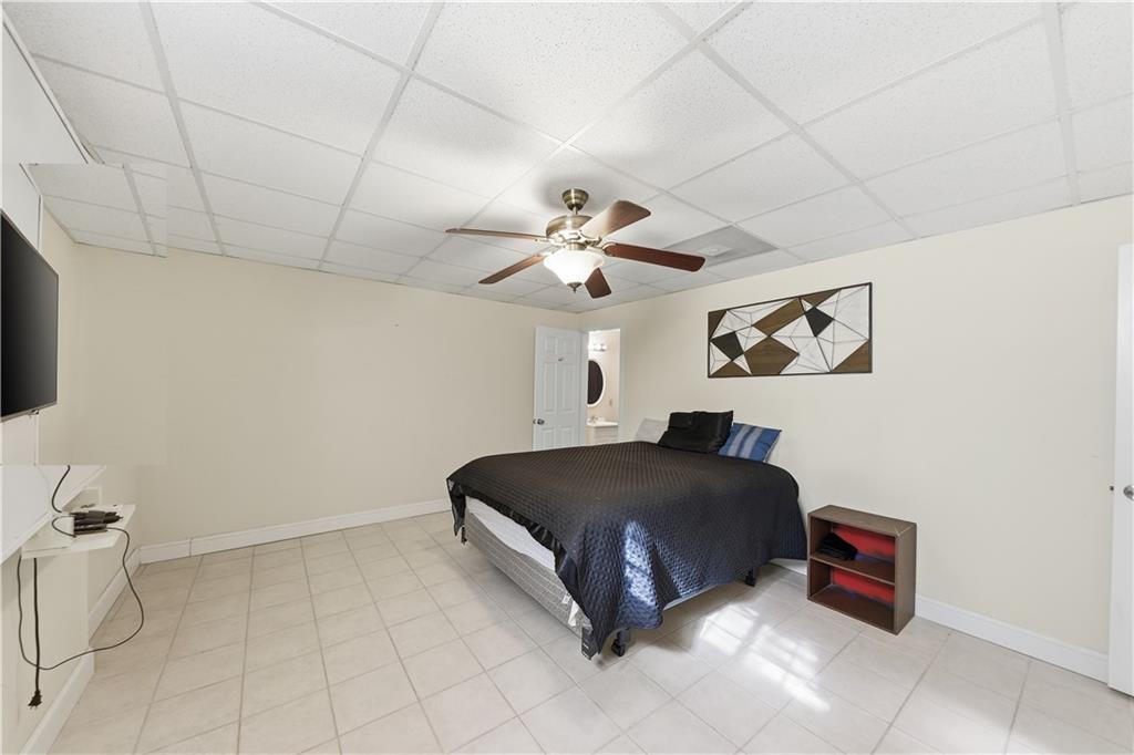 260 Tabor Forest Drive Oxford, GA 30054 - Photo 13 of 20 a spacious bedroom with a bed and a chandelier