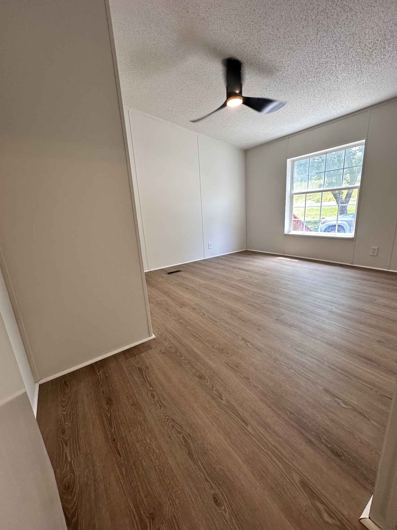 7287 Pinewood Road Nunnelly, TN 37137 - Photo 16 of 18 an empty room with wooden floor and windows