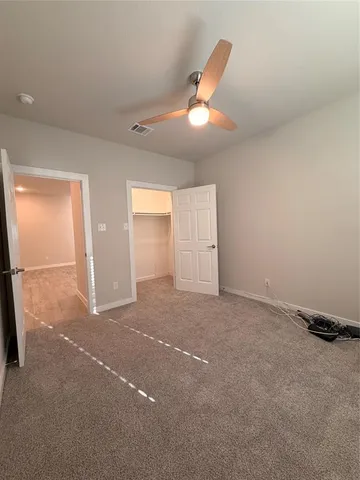 a view of a livingroom with a ceiling fan and window