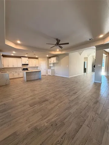 a large kitchen with kitchen island a sink a center island stainless steel appliances and a cabinets