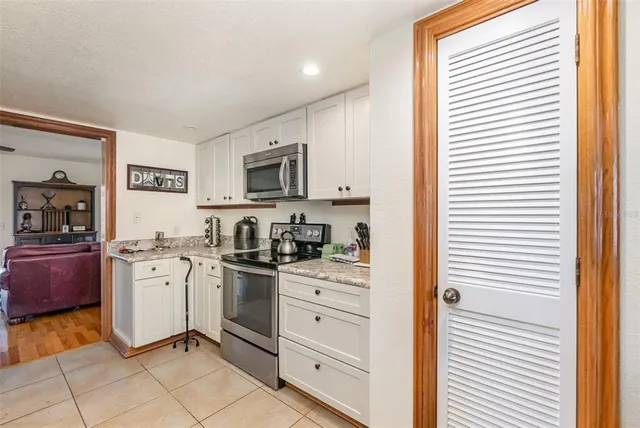 a kitchen with stainless steel appliances granite countertop a stove and a sink