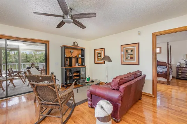 a living room with furniture or couch and a floor to ceiling window