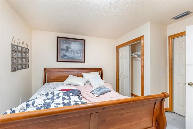 a bed sitting in a bedroom next to a window