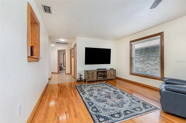 a living room with a flat screen tv and a rug