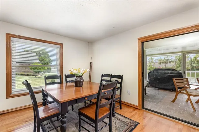 a dining room with furniture and wooden floor