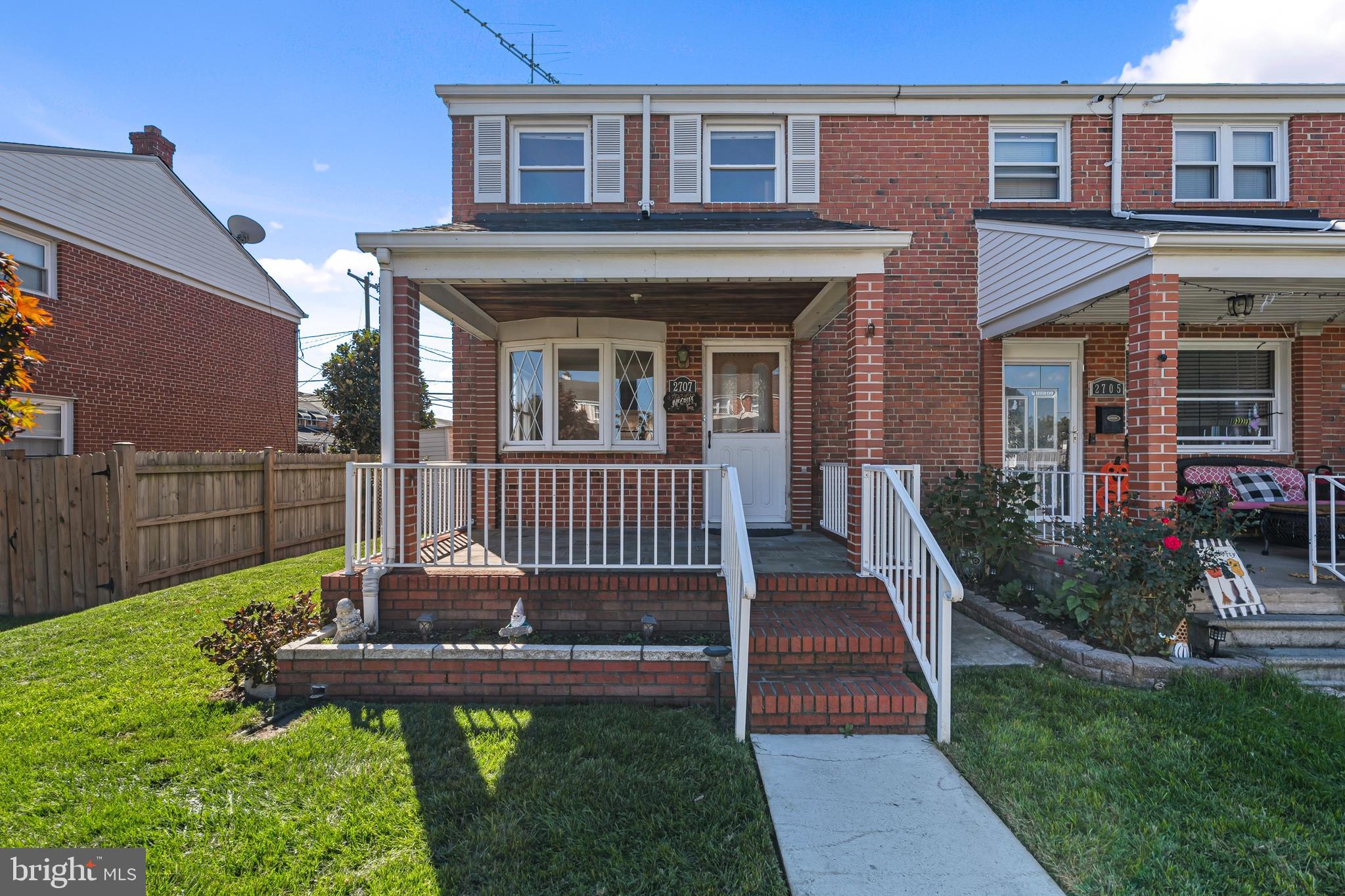 a front view of a house with yard and deck