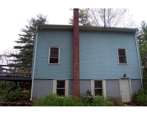 8 Skinners Road Groton, MA 01450 - Photo 20 of 21 a view of a house with a yard and wooden fence