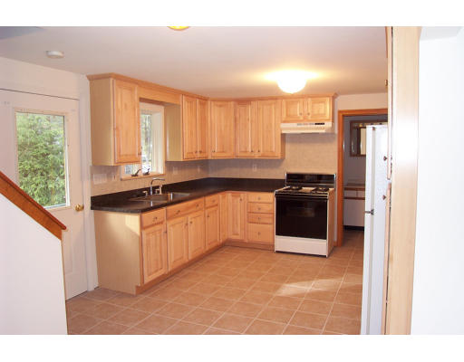 8 Skinners Road Groton, MA 01450 - Photo 2 of 21 a kitchen with stainless steel appliances granite countertop a stove a sink and a microwave
