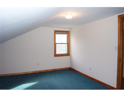 8 Skinners Road Groton, MA 01450 - Photo 10 of 21 a view of an empty room with wooden floor and a window
