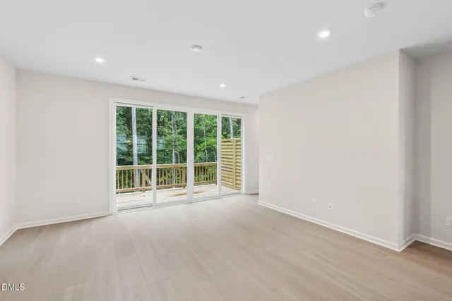 a kitchen with kitchen island granite countertop a sink and a stove top oven with wooden floor