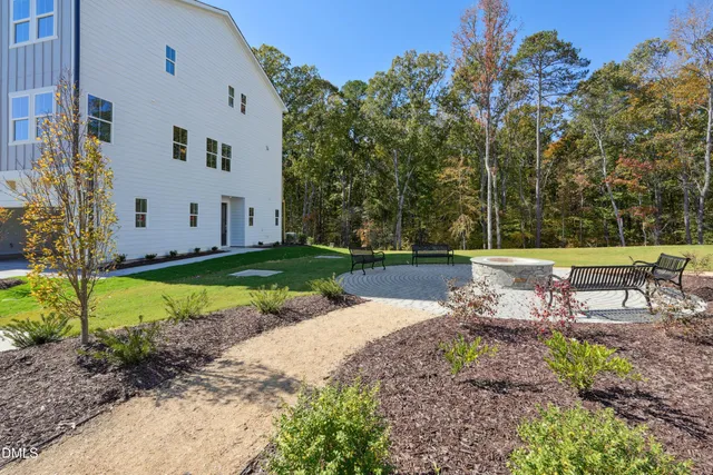 a swimming pool with outdoor seating and yard