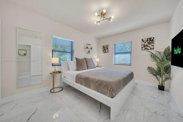 a bed room with a bed and a chandelier