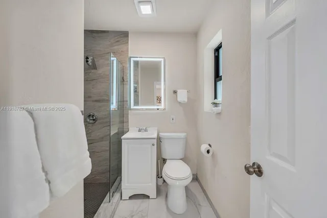a bathroom with a toilet and a shower