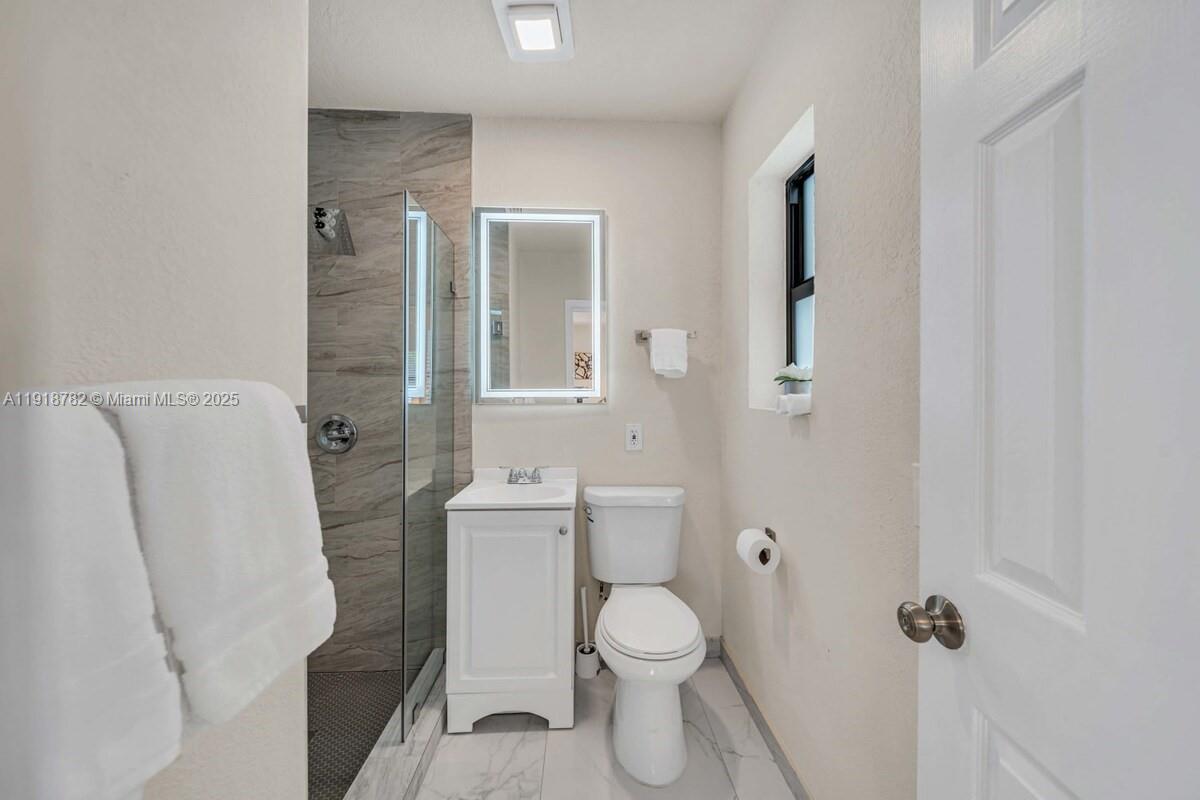305 Northwest 124th Street North Miami, FL 33168 - Photo 19 of 41 a bathroom with a toilet and a shower