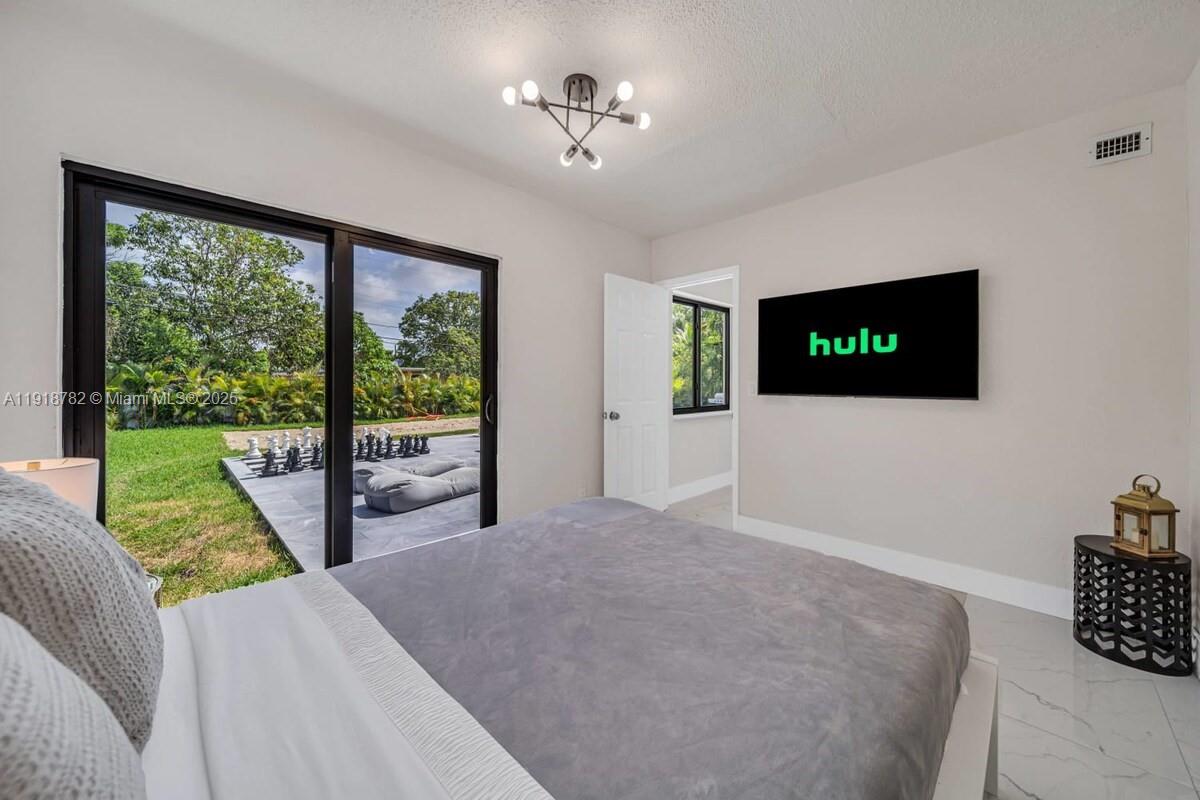 305 Northwest 124th Street North Miami, FL 33168 - Photo 21 of 41 a living room with furniture tv and a large window