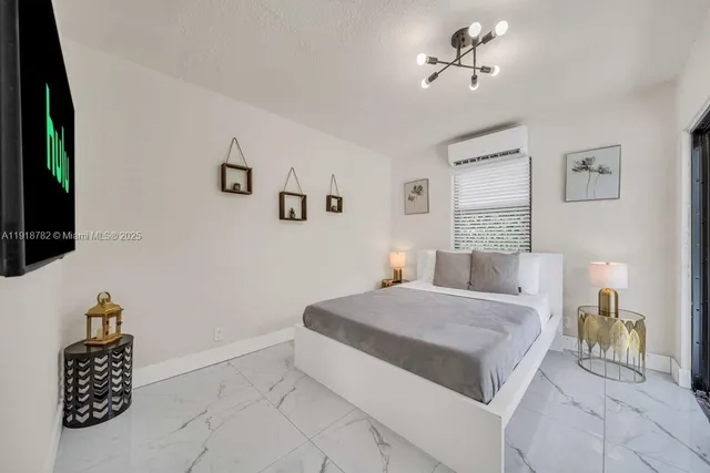 a bedroom with a bed and a chandelier