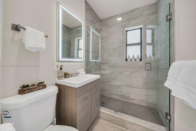 a bathroom with a sink toilet and shower