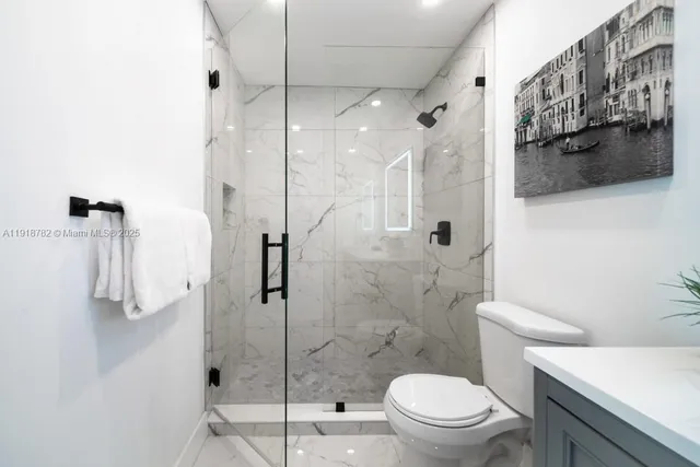 a bathroom with a shower a toilet and a sink