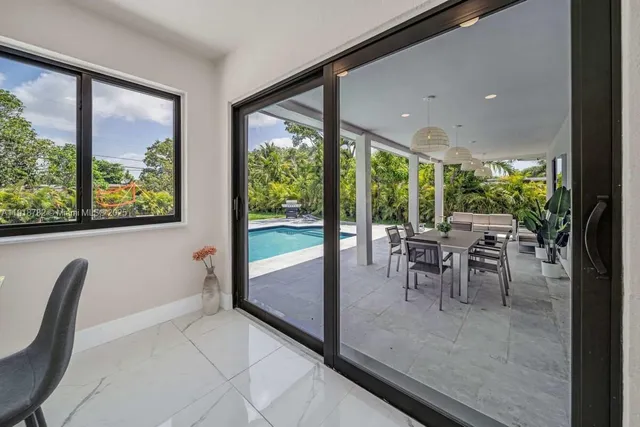 a view of a dining room with furniture window and outside view
