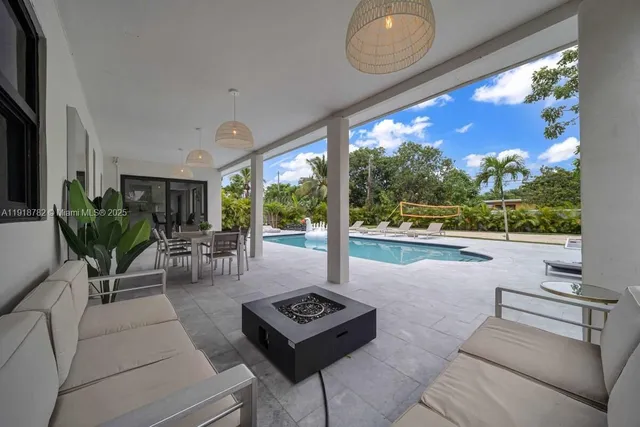 a living room with furniture and a floor to ceiling window