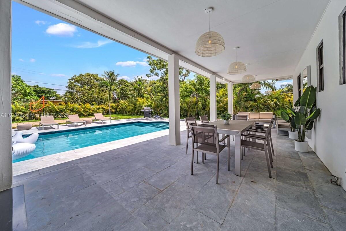 305 Northwest 124th Street North Miami, FL 33168 - Photo 36 of 41 a view of a patio with a table and chairs