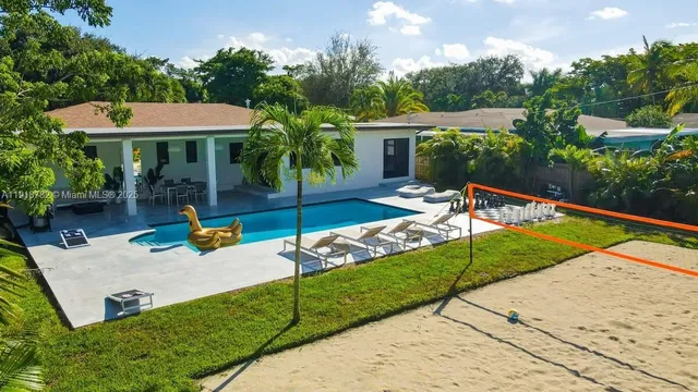 swimming pool view with a seating space