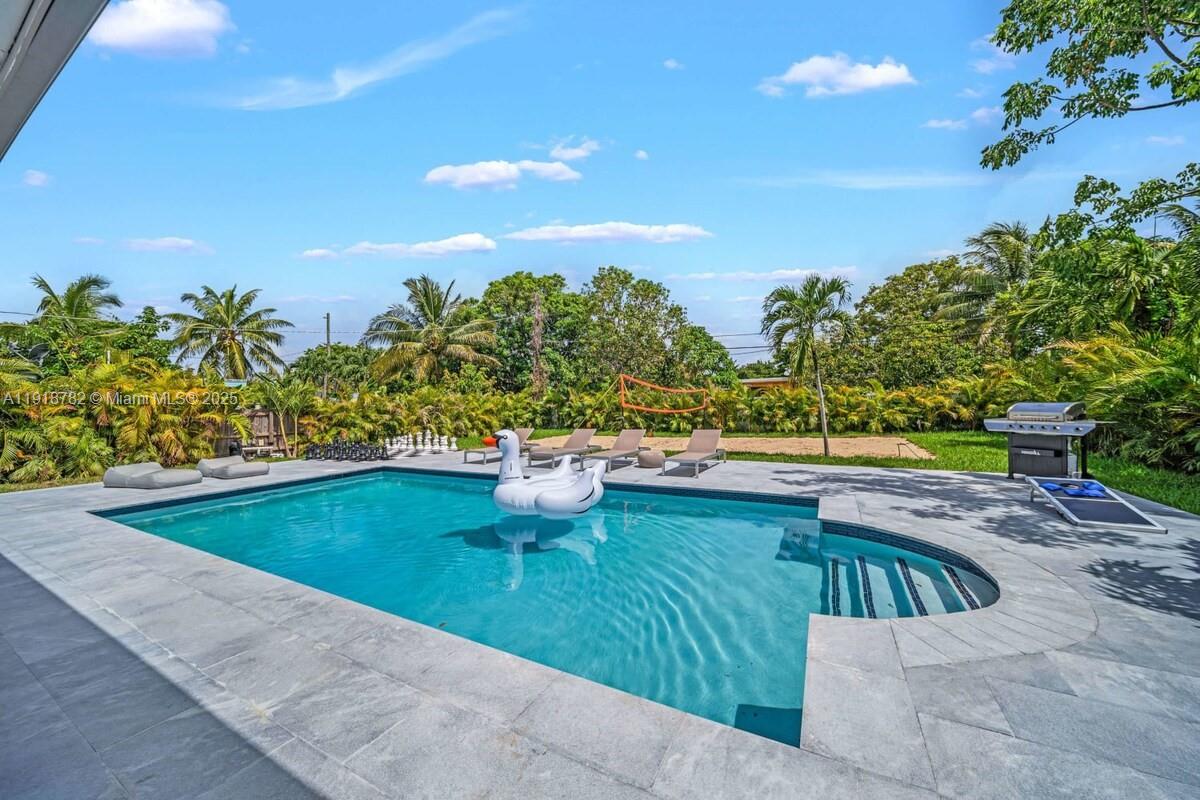 305 Northwest 124th Street North Miami, FL 33168 - Photo 38 of 41 a view of swimming pool with outdoor seating and plants