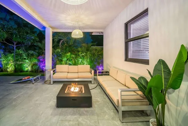 a building outdoor space with patio furniture and potted plants
