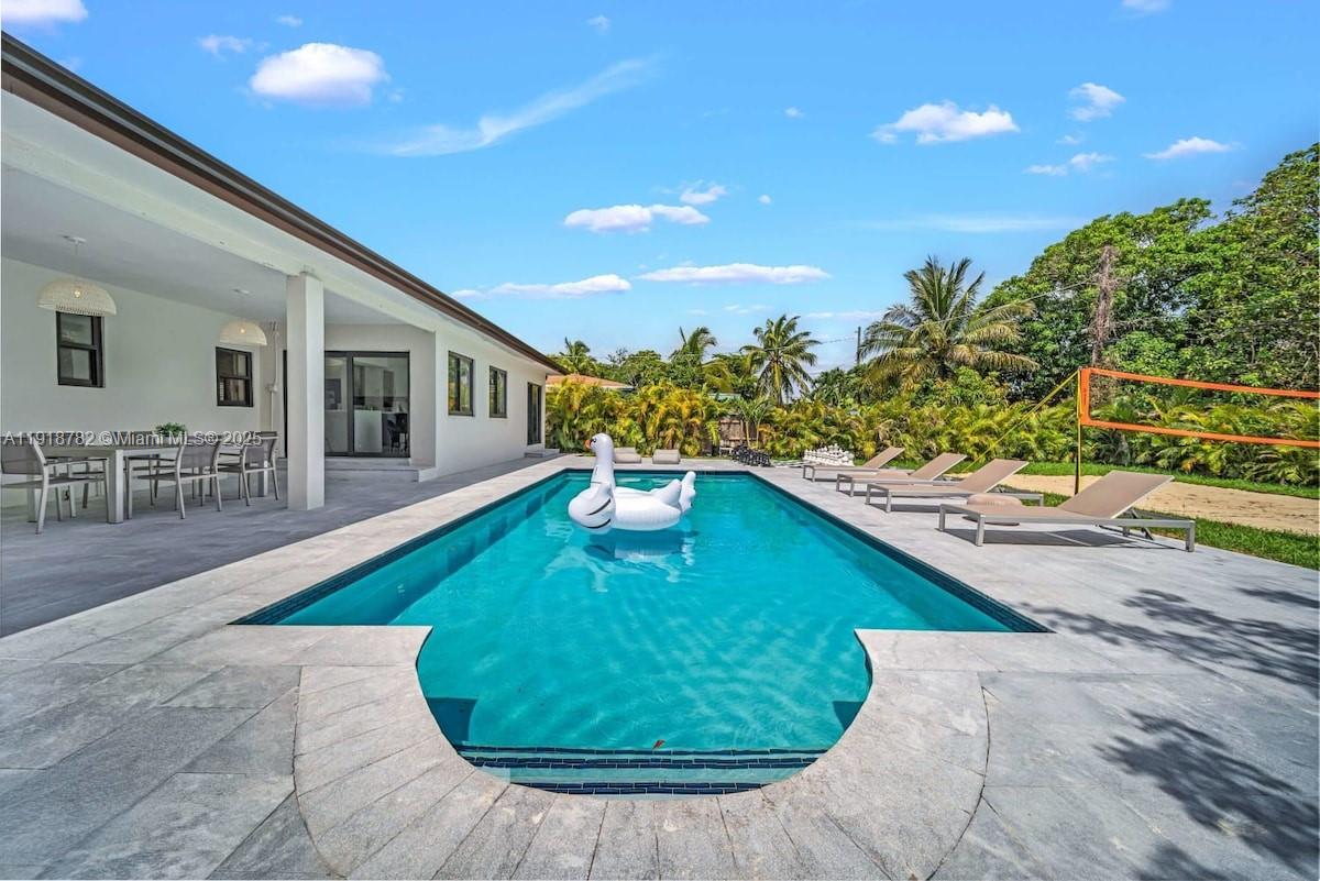 305 Northwest 124th Street North Miami, FL 33168 - Photo 4 of 41 a swimming pool with outdoor seating and yard