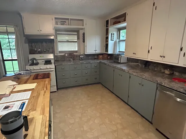 a kitchen with a stove a sink and a refrigerator